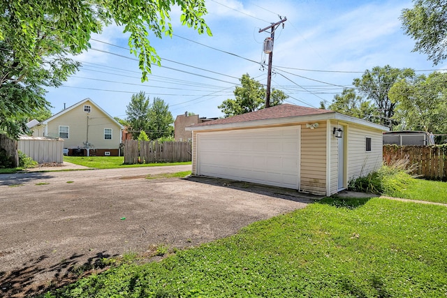 garage featuring a lawn