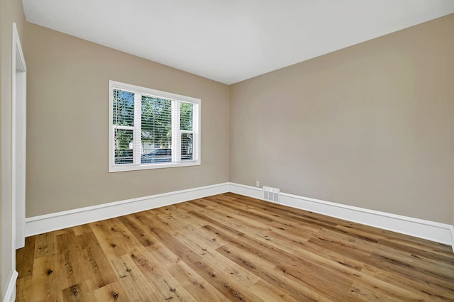 spare room with hardwood / wood-style flooring