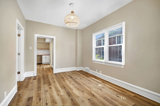 empty room with light hardwood / wood-style flooring