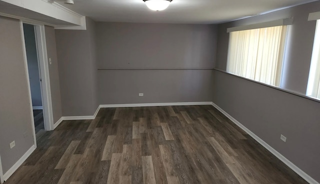 empty room featuring dark hardwood / wood-style flooring