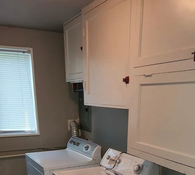 washroom featuring cabinets and independent washer and dryer