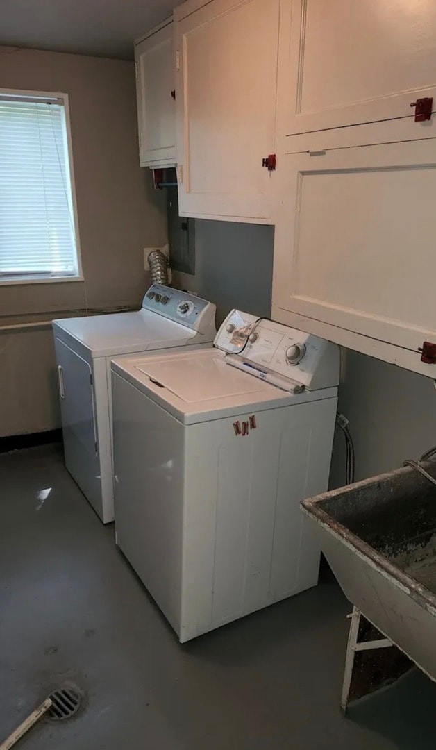 laundry room with washer and clothes dryer, cabinets, and sink