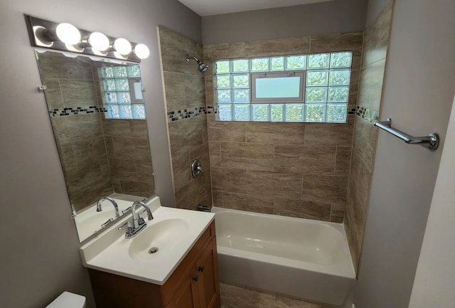 bathroom with vanity, tiled shower / bath combo, and plenty of natural light