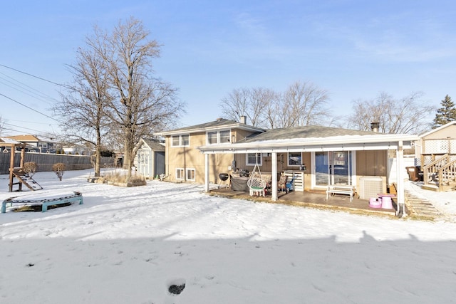 view of snow covered back of property