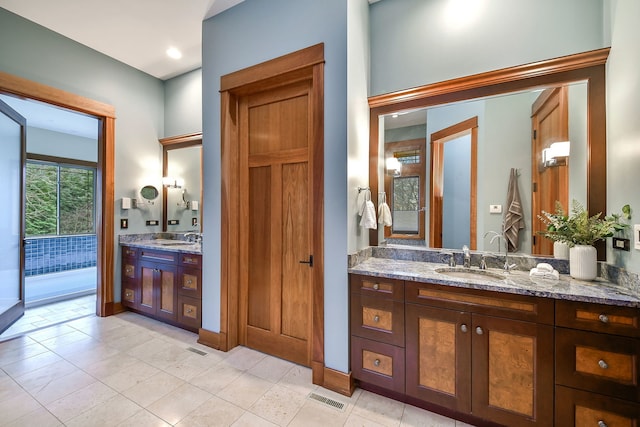 bathroom with vanity and tile patterned flooring