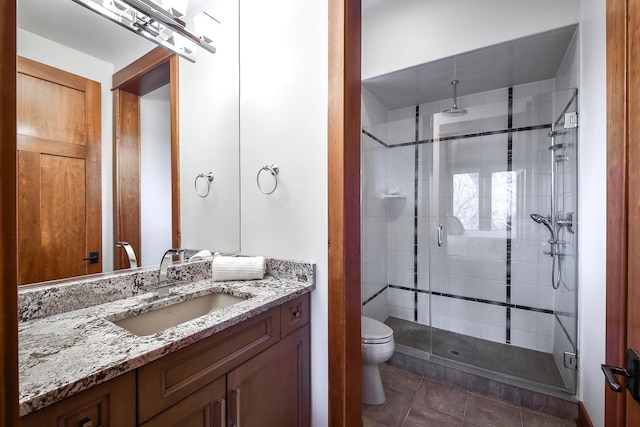 bathroom featuring vanity, an enclosed shower, tile patterned floors, and toilet