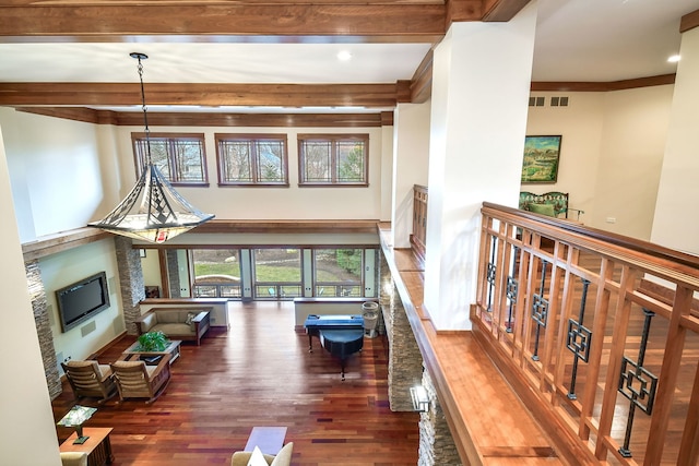 living room with beam ceiling, ornamental molding, and dark hardwood / wood-style floors