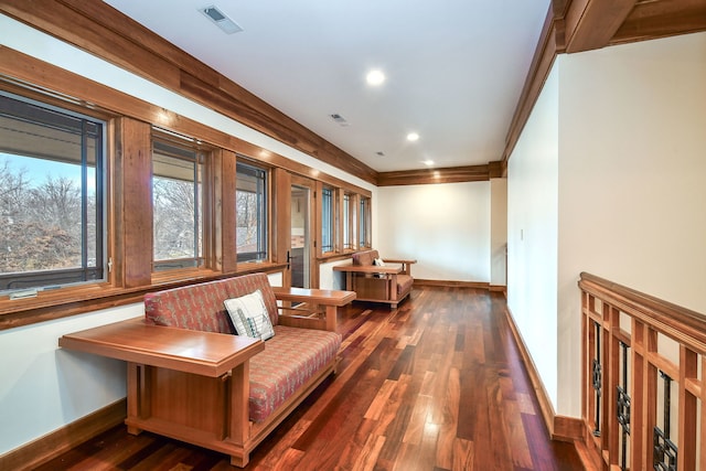 sitting room featuring crown molding and dark hardwood / wood-style flooring