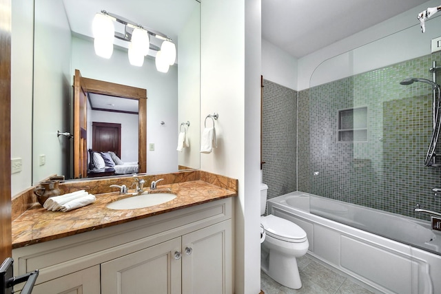 full bathroom featuring vanity, bath / shower combo with glass door, tile patterned floors, and toilet