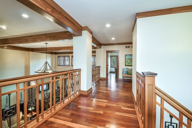 corridor featuring beamed ceiling, dark hardwood / wood-style flooring, and crown molding