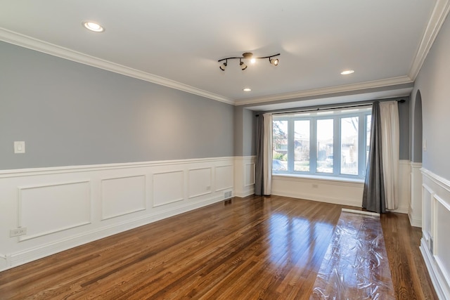 spare room featuring dark hardwood / wood-style flooring and ornamental molding