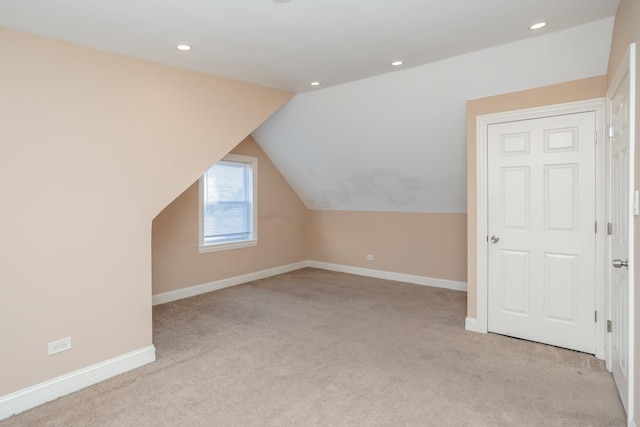 bonus room with light carpet and lofted ceiling