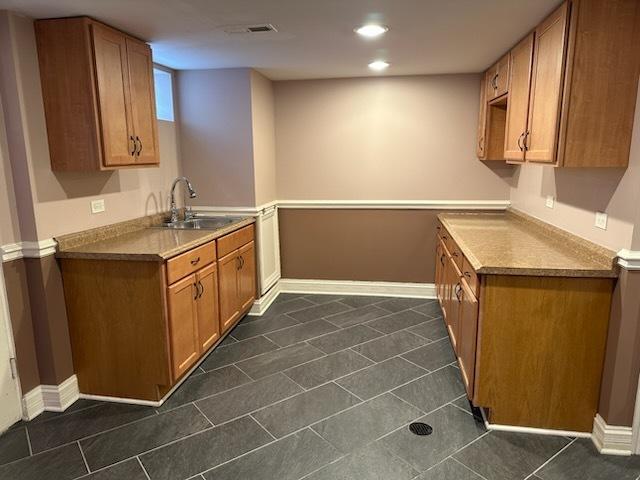 kitchen with dark tile patterned flooring and sink