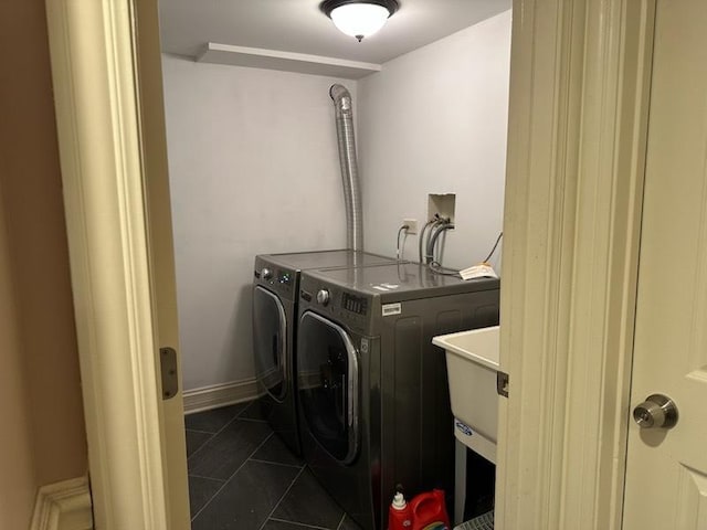 washroom featuring washer and dryer and dark tile patterned floors