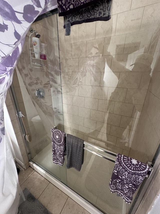 bathroom with tile patterned floors and a shower with shower door