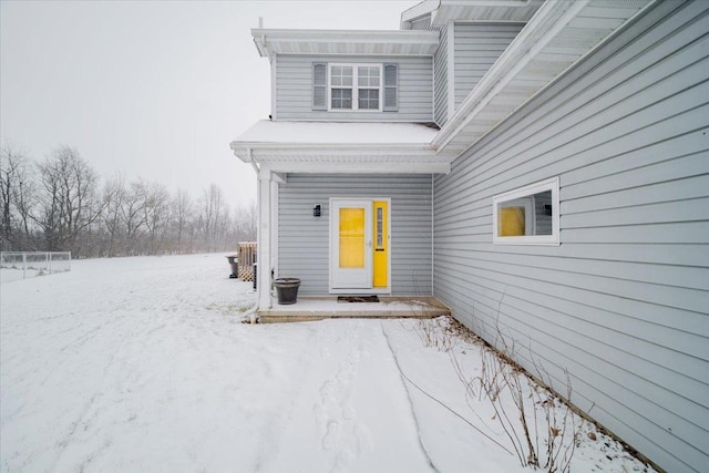 view of snow covered property entrance