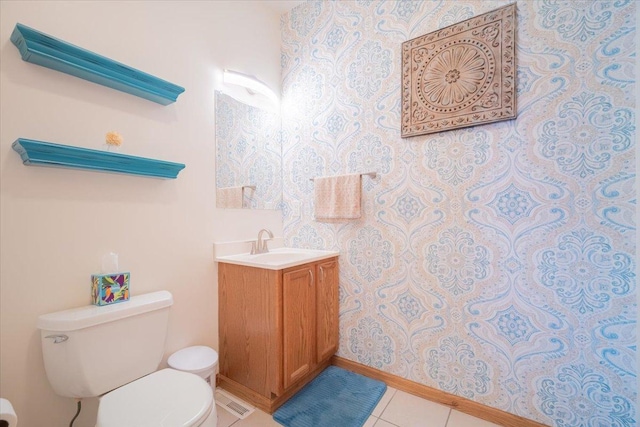 bathroom featuring vanity, tile patterned floors, and toilet