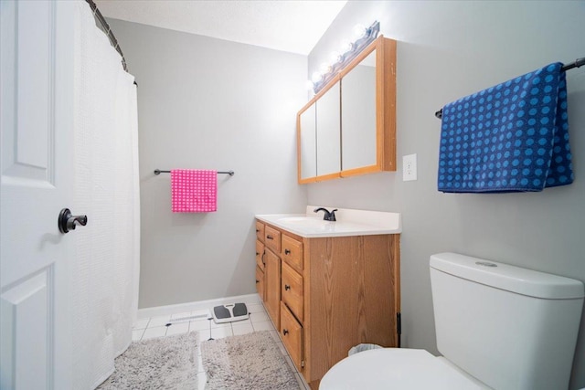 bathroom with toilet, tile patterned floors, and vanity