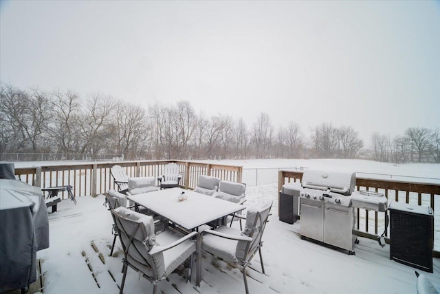 snow covered deck featuring a grill