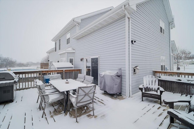 snow covered deck featuring a grill