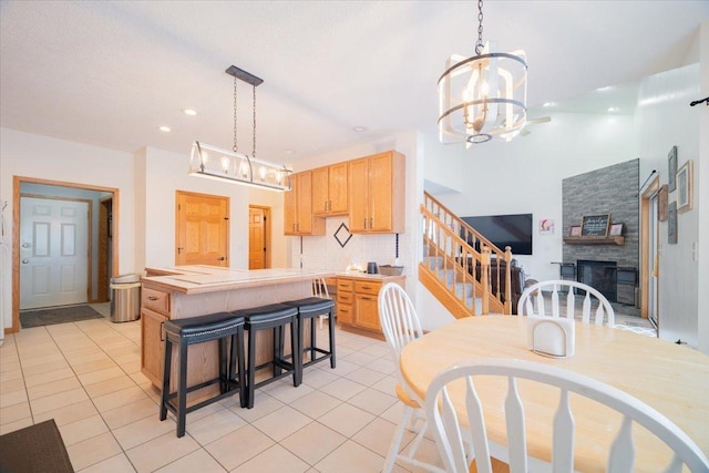 tiled dining room with a chandelier