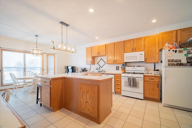 kitchen with backsplash, white appliances, pendant lighting, and light tile patterned floors