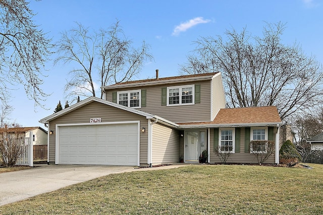 view of property with a garage and a front lawn