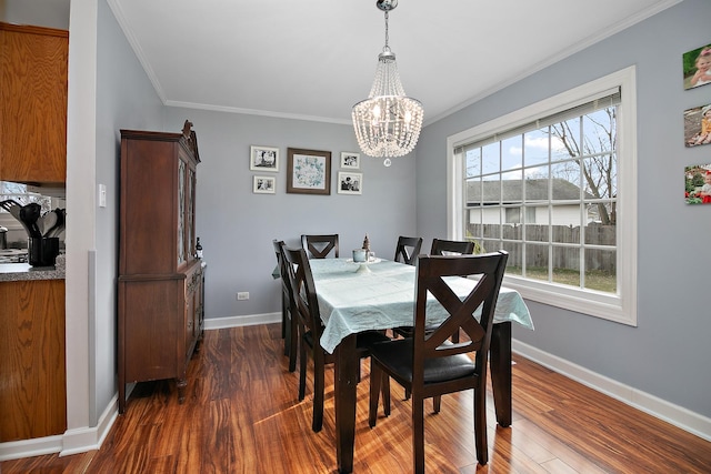 dining area with a healthy amount of sunlight, crown molding, dark wood-type flooring, and an inviting chandelier