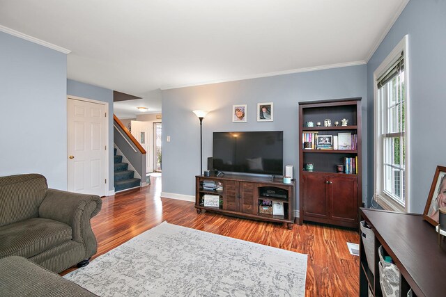 living room with hardwood / wood-style flooring and ornamental molding