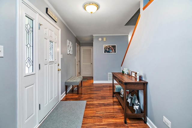 foyer with dark hardwood / wood-style flooring and ornamental molding