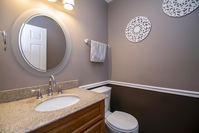 bathroom featuring vanity and toilet