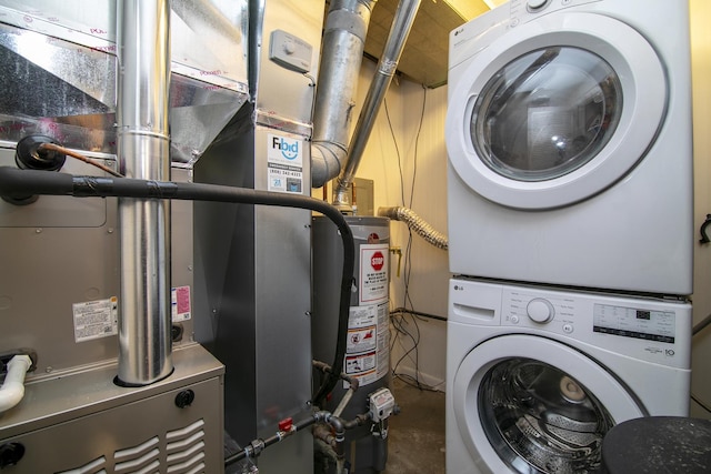 laundry room with stacked washer / drying machine and gas water heater