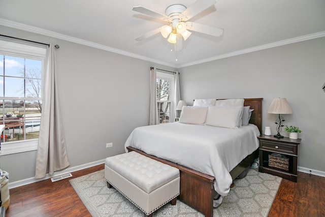 bedroom featuring ceiling fan, dark hardwood / wood-style floors, and crown molding