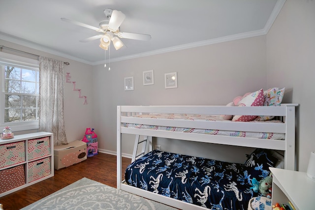 bedroom with ceiling fan, crown molding, and dark wood-type flooring