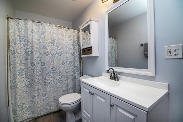 bathroom featuring vanity, hardwood / wood-style flooring, and toilet