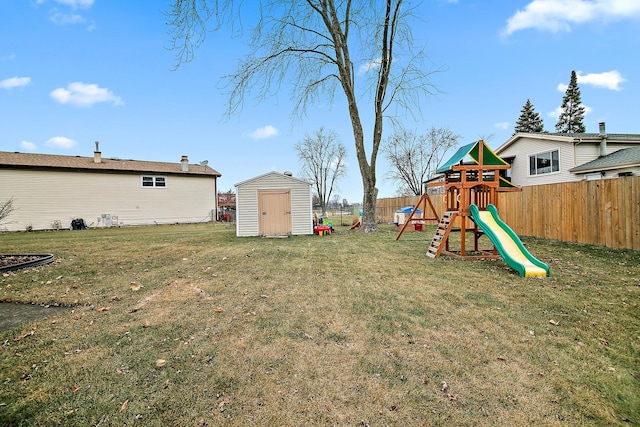 view of yard with a storage unit and a playground