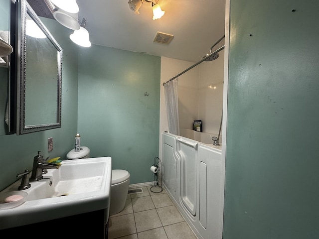 bathroom featuring tile patterned floors, vanity, and toilet