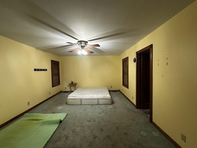 unfurnished bedroom featuring ceiling fan and carpet