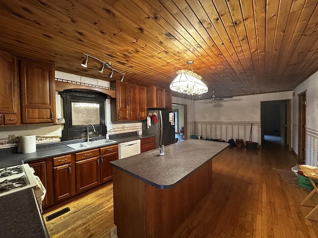 kitchen featuring pendant lighting, white appliances, sink, wood-type flooring, and wood ceiling