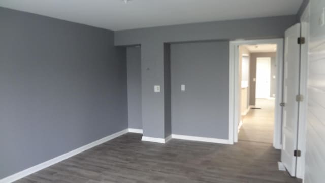 unfurnished bedroom featuring dark hardwood / wood-style flooring