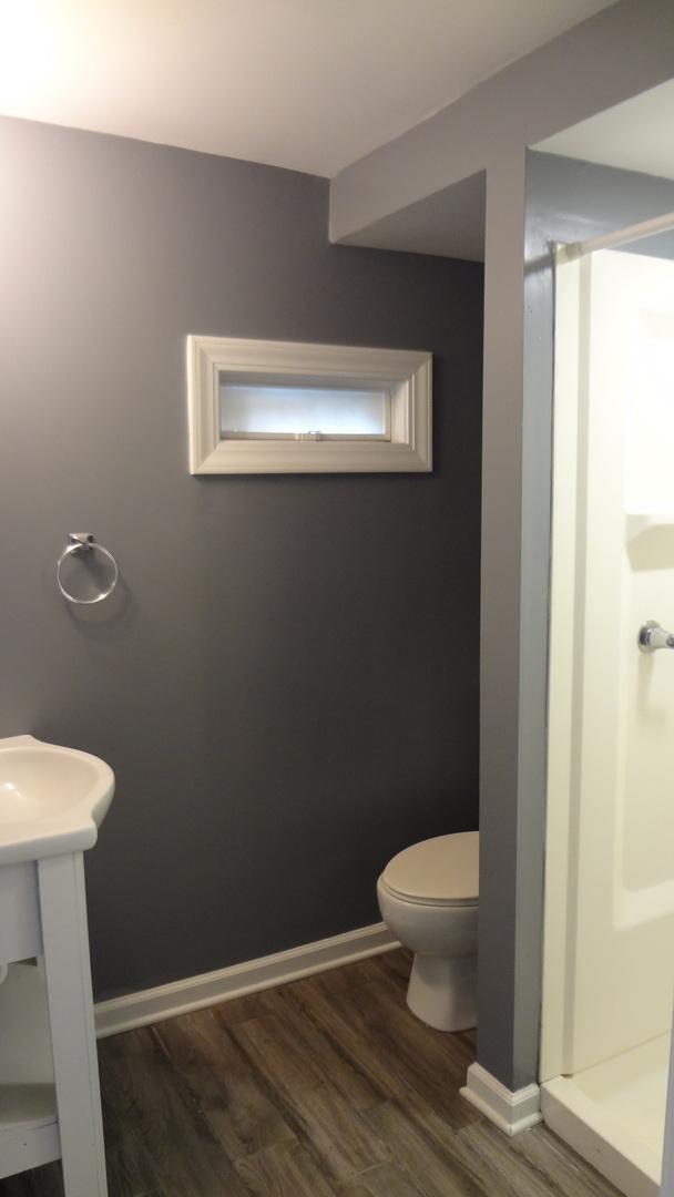 bathroom featuring wood-type flooring and toilet