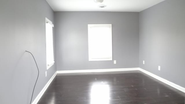 spare room featuring dark hardwood / wood-style flooring