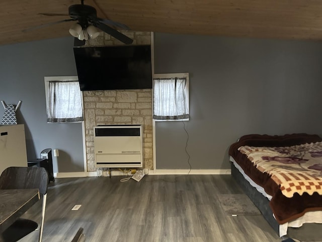 bedroom with heating unit, ceiling fan, lofted ceiling, and multiple windows