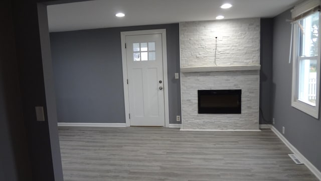 entrance foyer with hardwood / wood-style flooring and a fireplace