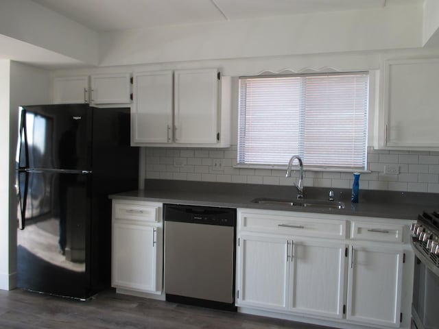 kitchen featuring white cabinets, dishwasher, black fridge, and sink