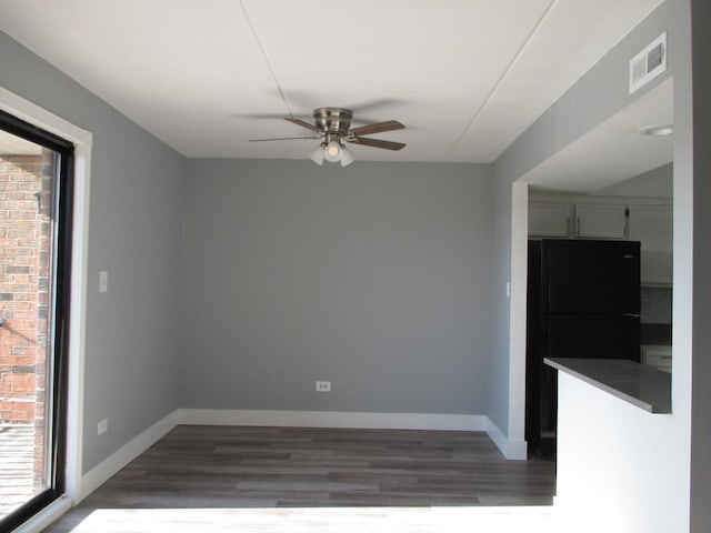 unfurnished dining area featuring ceiling fan and dark hardwood / wood-style flooring