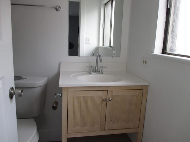 bathroom featuring vanity and toilet