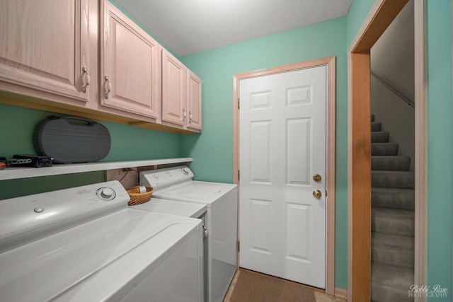 washroom featuring cabinets and separate washer and dryer