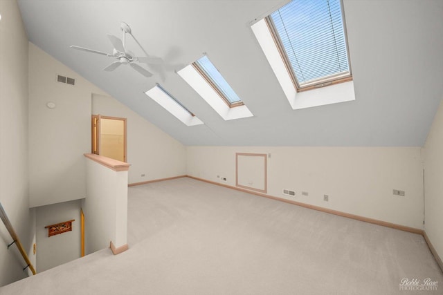 additional living space featuring ceiling fan, light carpet, and vaulted ceiling