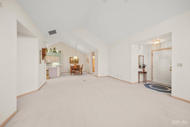 unfurnished living room with light carpet and lofted ceiling